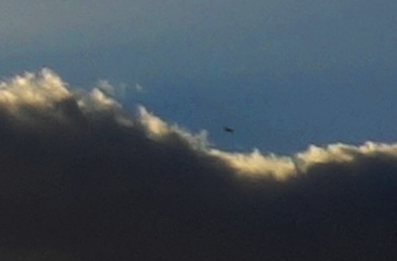 Enlargement, ship popping up from behind cloud bank, August 12, 2016.