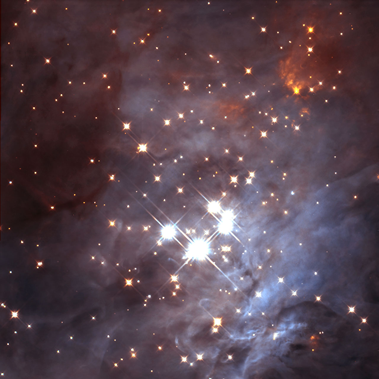 Appearing like glistening precious stones, the Trapezium cluster's central region is here seen through the eyes of the NASA/ESA Hubble Space Telescope. All of the celestial objects in the Trapezium were born together in this hotbed of star formation. The c